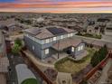Aerial view of house with solar panels, fenced yard, patio and fire pit at 13960 Box Turtle Loop, Parker, CO 80134
