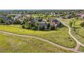 Aerial view of a residential community with walking path, showcasing houses and landscaping at 10660 Weathersfield Ct, Highlands Ranch, CO 80129