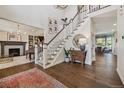 Grand entryway with a staircase, hardwood floors, and views into the formal dining and living rooms at 10660 Weathersfield Ct, Highlands Ranch, CO 80129