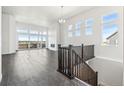 Bright, open living room with large windows, fireplace, and dark hardwood flooring at 3884 Freestone Pt, Castle Rock, CO 80108