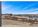 Expansive neighborhood view from a high vantage point on a bright, sunny day at 3884 Freestone Pt, Castle Rock, CO 80108