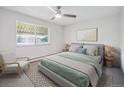 Serene bedroom with a ceiling fan and plush neutral bedding at 635 S Alton Way # 1C, Denver, CO 80247