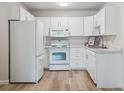 Efficient kitchen featuring modern white appliances and granite countertops at 635 S Alton Way # 1C, Denver, CO 80247