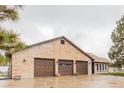 Spacious three-car garage with brick facade, offering ample parking and storage at 1341 Tomichi Dr, Franktown, CO 80116
