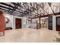 Open living room features light wood floors and exposed beam vaulted ceiling at 1341 Tomichi Dr, Franktown, CO 80116