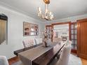 Elegant dining room with a long table, decorative lighting, and doorway at 926 S Fillmore Way, Denver, CO 80209