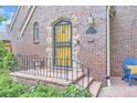 Close up of a classic brick home featuring an inviting front door, stylish details and landscaping at 926 S Fillmore Way, Denver, CO 80209
