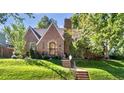 Charming brick home featuring a manicured front lawn and inviting entrance at 926 S Fillmore Way, Denver, CO 80209