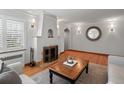 Bright living room with hardwood floors, fireplace, and natural light at 926 S Fillmore Way, Denver, CO 80209