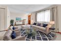 Cozy living room featuring stylish decor, a plush sofa, and an elegant glass coffee table at 3061 W 92Nd Ave # 8B, Westminster, CO 80031