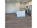 Bright kitchen featuring white cabinetry, stainless steel appliances, and an island with sink at 6731 Arbor E Blvd, Thornton, CO 80602