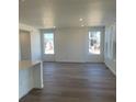 Bright living room with hardwood floors and large windows offering lots of natural light at 6731 Arbor E Blvd, Thornton, CO 80602