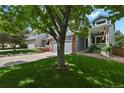 Inviting home with a manicured lawn, mature tree, and partial view of a well-kept exterior at 9665 Whitecliff Pl, Highlands Ranch, CO 80129