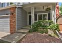 Cozy covered porch with decorative plants, offering a warm welcome to the home at 9665 Whitecliff Pl, Highlands Ranch, CO 80129