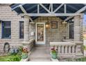Inviting front porch featuring stone columns, decorative railing, and a bright, welcoming entrance at 194 S Emerson St, Denver, CO 80209