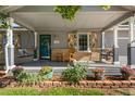 Inviting covered front porch with swing chairs, decorative shutters, potted plants, and attractive exterior details at 10640 Nw Routt Way, Westminster, CO 80021