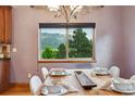 Inviting dining room featuring a large window with views of the surrounding mountains at 20401 High Pines Dr, Monument, CO 80132