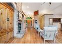 Inviting living room featuring a stone fireplace, hardwood floors, and an open layout at 20401 High Pines Dr, Monument, CO 80132