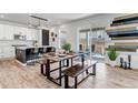 Contemporary dining area with a wooden table, benches, and a view of the outdoor deck at 2089 S Fultondale Way, Aurora, CO 80018