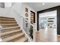 Bright staircase with carpeted steps, white railings, with a dining area visible in the background at 2089 S Fultondale Way, Aurora, CO 80018