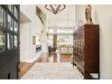 Stunning foyer with soaring ceilings, elegant light fixtures, hardwood floors, and a view of the inviting living space beyond at 5425 S University Blvd, Greenwood Village, CO 80121