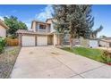 Attractive two-story house with a well-maintained lawn, dual garage, and brick accents at 18751 E Mexico Ave, Aurora, CO 80017