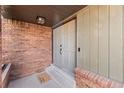 Charming front porch with double doors, brick accents and a cute welcome mat at 11037 Cambridge Pl, Parker, CO 80138