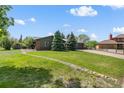 Single Gathering home with lush green lawn, mature trees, and a long driveway at 11037 Cambridge Pl, Parker, CO 80138