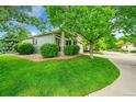 Charming home with a well-maintained lawn and attractive landscaping at 10571 Garfield St, Thornton, CO 80233
