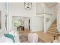 Open-concept living room with high ceilings, dining area, and staircase to loft, offering bright and airy space at 10703 Jordan Ct, Parker, CO 80134