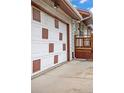 Side view of a garage door with square designs, complemented by the home's architecture at 6327 Fenton St, Arvada, CO 80003