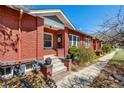 Charming brick home with a well-maintained front yard and inviting entryway at 2023 E 20Th Ave, Denver, CO 80205