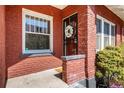 Lovely front porch with brick, a floral wreath, and a decorative welcome mat at 2023 E 20Th Ave, Denver, CO 80205