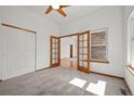 Comfortable bedroom boasting a ceiling fan, large window, and a closet for ample storage at 14447 Inca Ct, Westminster, CO 80023