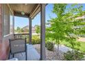 Cozy front porch with seating area, perfect for enjoying the neighborhood views at 1199 Hummingbird Cir, Longmont, CO 80501