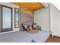 Inviting front porch featuring stylish seating and decorative stone accents at 2230 Rim Ridge Dr, Castle Pines, CO 80108