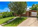 Well-maintained brick home with a driveway and detached garage at 3182 W Radcliff Dr, Englewood, CO 80110