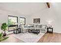 Bright living room featuring hardwood floors, natural light, and comfortable furniture at 3260 Bit Rd, Evergreen, CO 80439