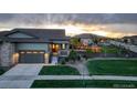 Charming single-Gathering home with a two-car garage, well-manicured lawn, and a welcoming front porch enhanced by an inviting walkway at 7029 Sagerock St, Castle Pines, CO 80108