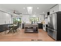 Modern kitchen with stainless appliances, island, white subway tile, breakfast nook, and access to the deck at 6742 Cole Cir, Arvada, CO 80004