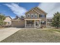 Charming two-story home featuring a covered porch, stone accents, and well-maintained landscaping at 4206 Eagle Ridge Way, Castle Rock, CO 80104