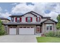 Charming two-story home featuring a stone facade, three-car garage, and striking red shutters at 24556 E Ottawa Ave, Aurora, CO 80016