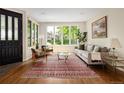 Bright living room with hardwood floors, a large window and stylish decor at 355 Steele St, Denver, CO 80206