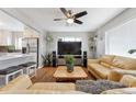 Open-concept living room showcasing hardwood floors, neutral walls, and access to the kitchen at 7624 Navajo St, Denver, CO 80221