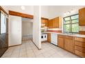 Bright kitchen features tile flooring, white appliances, and ample cabinet space at 4717 Tantra Dr # G5, Boulder, CO 80305