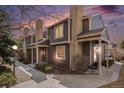 Attractive two-story townhome with brick accents, covered porches, and mature landscaping at sunset at 804 Summer Dr, Highlands Ranch, CO 80126