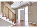 Bright entryway with hardwood floors, staircase and a door with frosted glass at 3232 S Leyden St, Denver, CO 80222