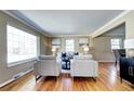 Bright living room featuring hardwood floors, two gray chairs and lots of natural light at 3232 S Leyden St, Denver, CO 80222