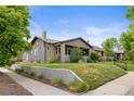 Charming bungalow with a well-kept lawn and landscaping, showcased from a corner street view at 2703 N Milwaukee St, Denver, CO 80205