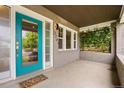 Welcoming front porch with a vibrant blue door, green climbing plants, and the house number at 2703 N Milwaukee St, Denver, CO 80205